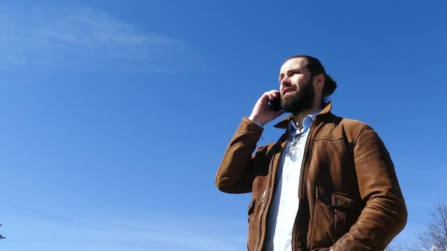 The man actively swears with the interlocutor on the phone