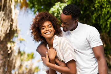 Outdoor protrait of black african american couple embracing each other - Powered by Adobe