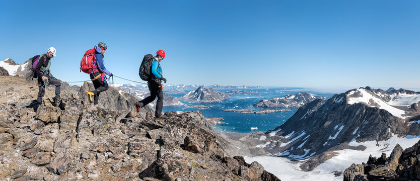 Greenland, Sermersooq, Kulusuk, Schweizerland Alps, mountaineers walking in rocky mountainscape