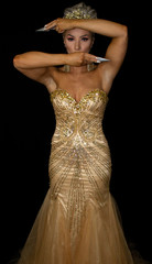 Fototapeta premium Golden goddess in crown, toying with knives