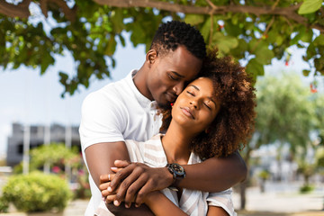 Outdoor protrait of black african american couple embracing each other - Powered by Adobe