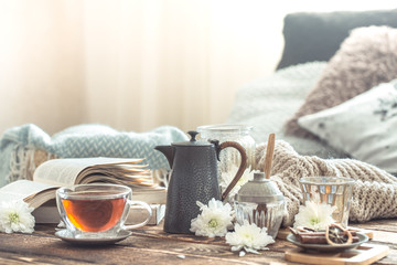 Still life details of home interior on a wooden table with a Cup of tea