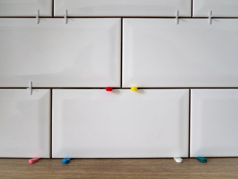 Masonry on the wall of white ceramic tiles. Bathroom or kitchen renovation