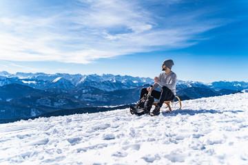Germany, Bavaria, Brauneck, man in winter in the mountains having a break