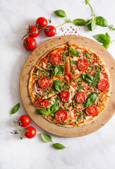 Overhead view of fresh homemade veggie pizza with ingredients