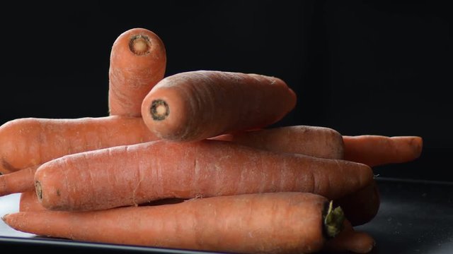 Raw natural carrots vegetables in a pile gyrating. Daucus carota
