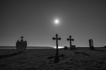 Historic graveyard in moonlight