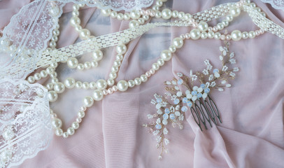 Wedding background with pearls and hair accessories on pink background