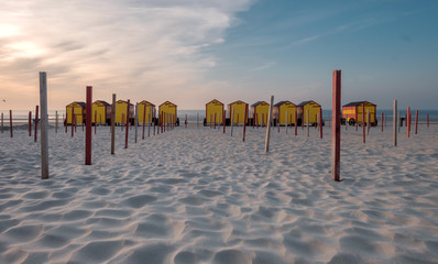 Vintage beach huts on the Belgian coast at sunset