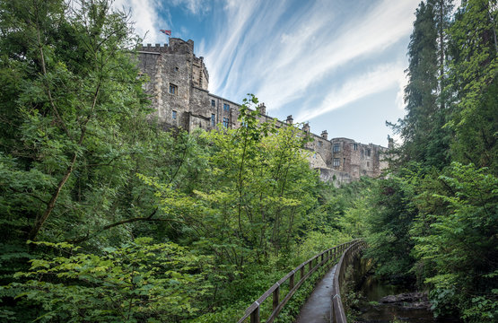 Panoramic view on Skipton Castle as seen from the footbridge in Skipton Woods