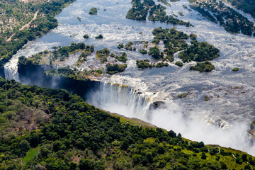 Victoria Falls from aerial view. Waterfall in southern Africa on the Zambezi River at the border...