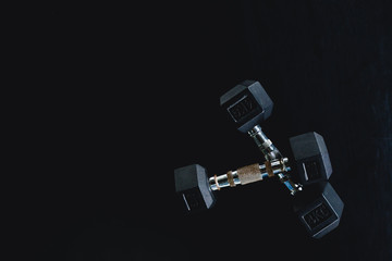 Background view back and white equipment dumbbells on floor in the gym sport center