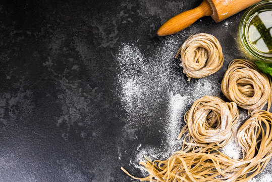 Raw uncooked homemade pasta ingredients, border background
