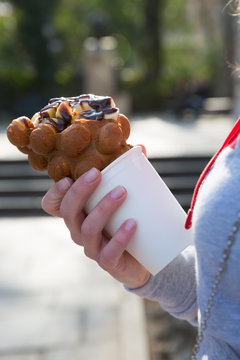 Hand with bubble waffle ice cream photo for graphic and web design, for website or mobile app.