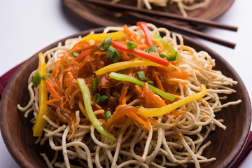 American chop suey/ chopsuey is a popular indochinese food. served in a bowl with chop sticks. selective focus
