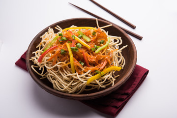 American chop suey/ chopsuey is a popular indochinese food. served in a bowl with chop sticks. selective focus