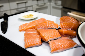 Pieces of sliced salmon fillet lie on a white sheet