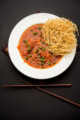 American chop suey/ chopsuey is a popular indochinese food. served in a bowl with chop sticks. selective focus