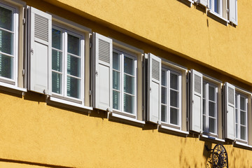 orange historical house facades on blue sky