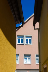 orange historical house facades on blue sky