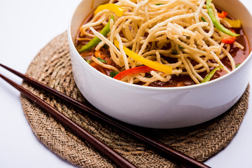 American chop suey/ chopsuey is a popular indochinese food. served in a bowl with chop sticks. selective focus