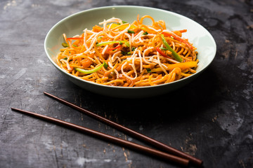 American chop suey/ chopsuey is a popular indochinese food. served in a bowl with chop sticks. selective focus