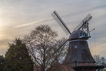 Fototapeta premium A beautiful typical East Frisian windmill in the sunset. Germany, westgrossefehn.