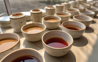 Tea tasting and testing during the manufacturing process at a tea factory in the state of Assam in India