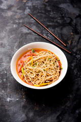 American chop suey/ chopsuey is a popular indochinese food. served in a bowl with chop sticks. selective focus