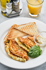 Omelet with herbs, bread and butter. Healthy breakfast