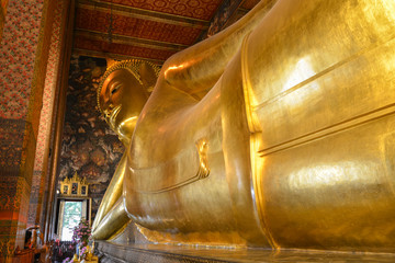 Reclining or Sleeping Buddha big golden statue in Wat Pho Temple complex in Bangkok, Thailand. Cultural and spiritual giant landmark.