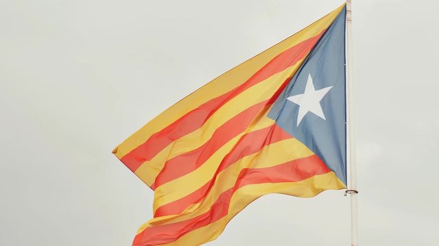 Flag of Catalonia against the blue sky.