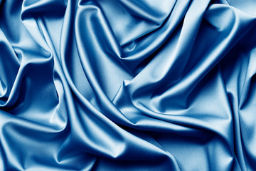 The texture of the satin fabric of blue color for the background