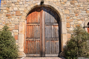 Fototapeta na wymiar Old Grunge countryside wood door and sandstone wall