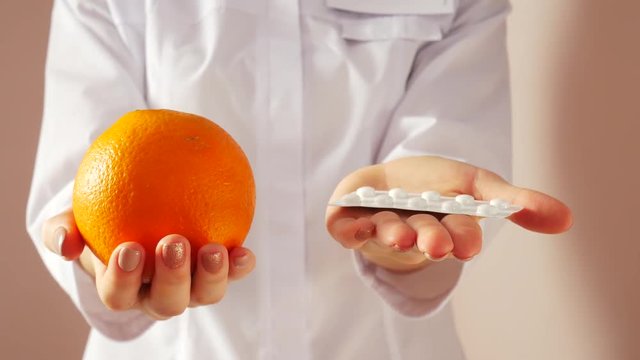 Doctor advising to eat healthy. Choose healthy food, not pills.