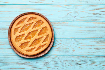 tasty  cake with jam on а blue wooden background