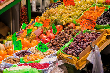 Colored dried fruit in an italian market with dates in the foreground