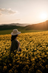 Fototapeta premium Unrecognizable woman walking among flowers