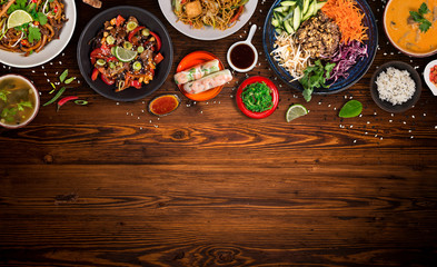 Asian food background with various ingredients on rustic wooden table , top view.