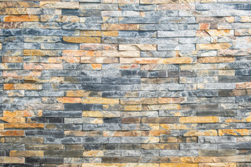 brick wall , texture of milti colored stone blocks closeup