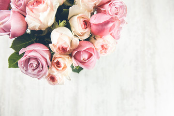 pink roses on the wooden desk