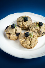 Fresh Baked Raspberry and Blueberry oatmeal wheat Scones set on Blue Background.