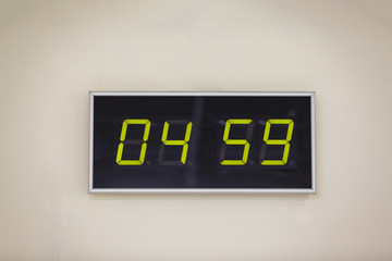 Black digital clock on a white background showing time 04.59 minutes