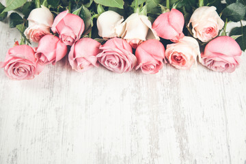 pink roses on the wooden desk