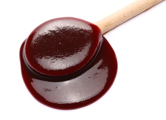 hip jam, marmalade with wooden spoon isolated on white background and texture