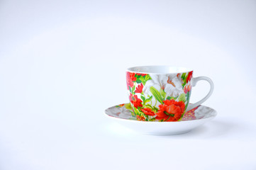 cup on saucer on table on white background