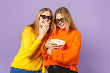 Two laughing young blonde twins sisters girls in 3d imax glasses