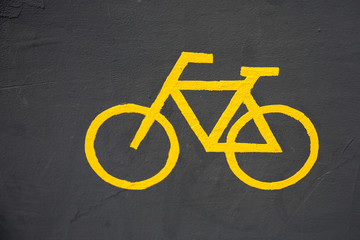 Photo of bicycle yellow sign on ground for graphic and web design, for website or mobile app.