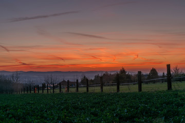 Fototapeta na wymiar Red and orange sunset sky near Ceske Budejovice city in spring evening