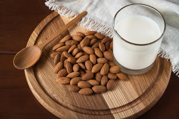 almond milk and almond on a wooden table from above